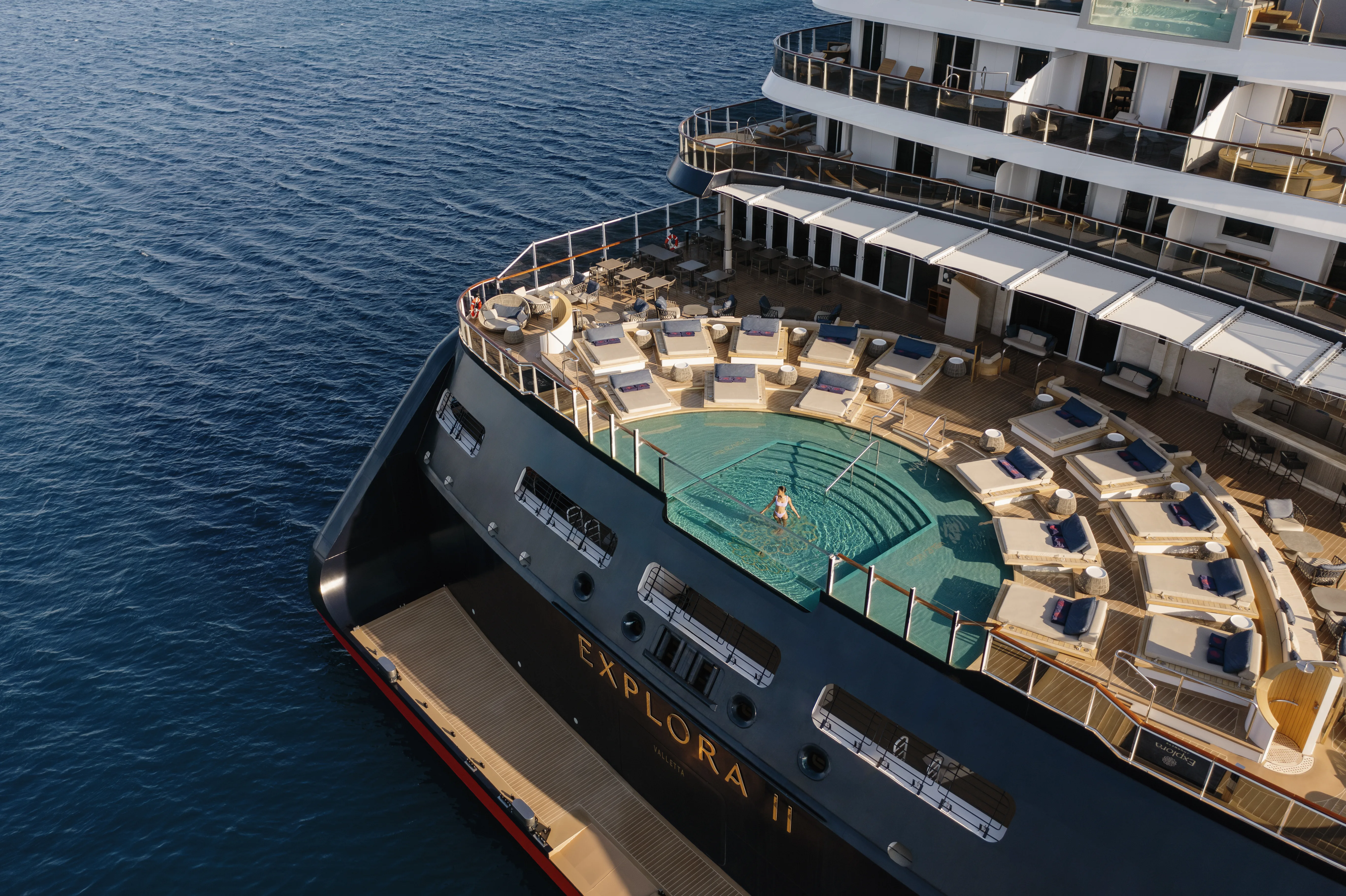 Aerial view of EXPLORA II stern pool deck at anchor in Paros, Greece
